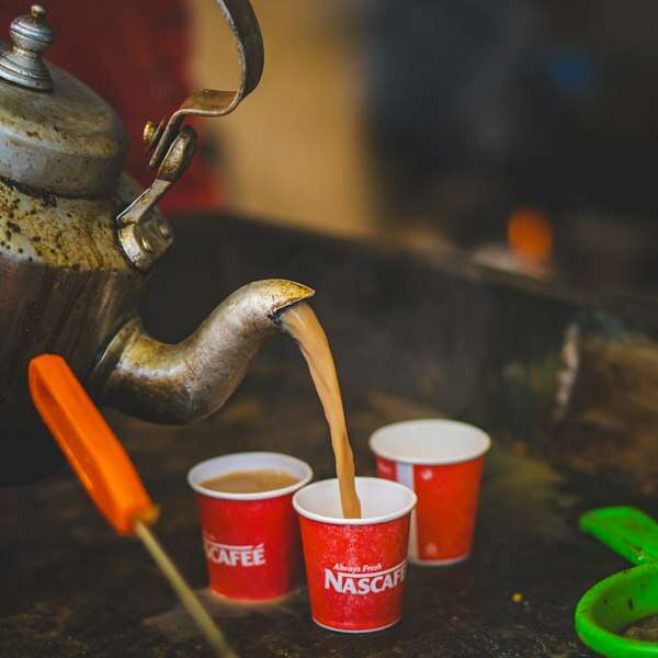 Assam chai being poured into cups