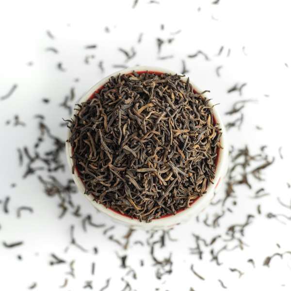 Dry black tea leaves in a cup