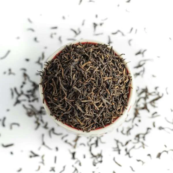 Dry black tea leaves in a cup