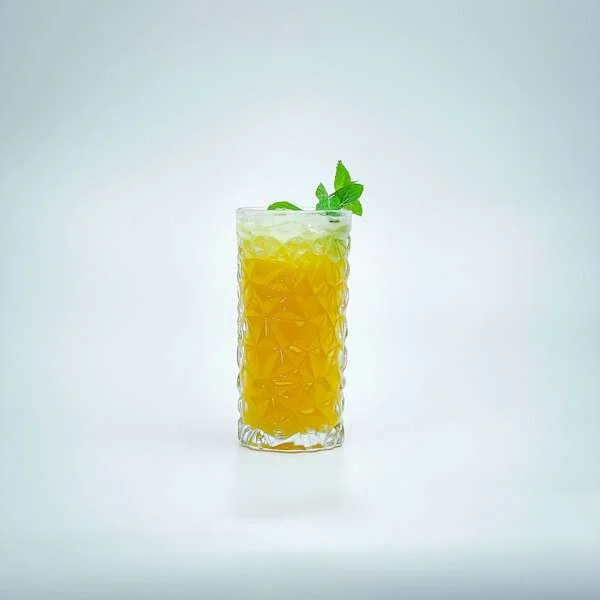 Glass of green tea with a fresh leaf